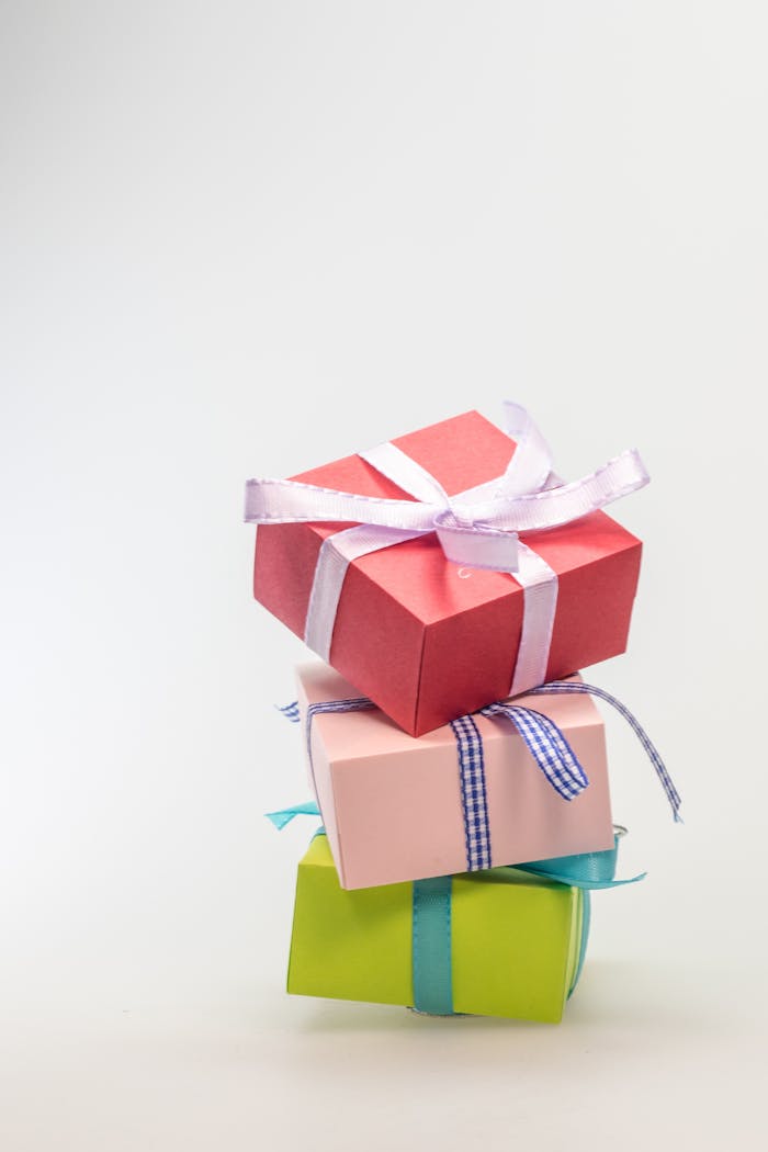 why-choose-us A stack of colorful gift boxes tied with ribbons, perfect for celebrations and festive occasions.